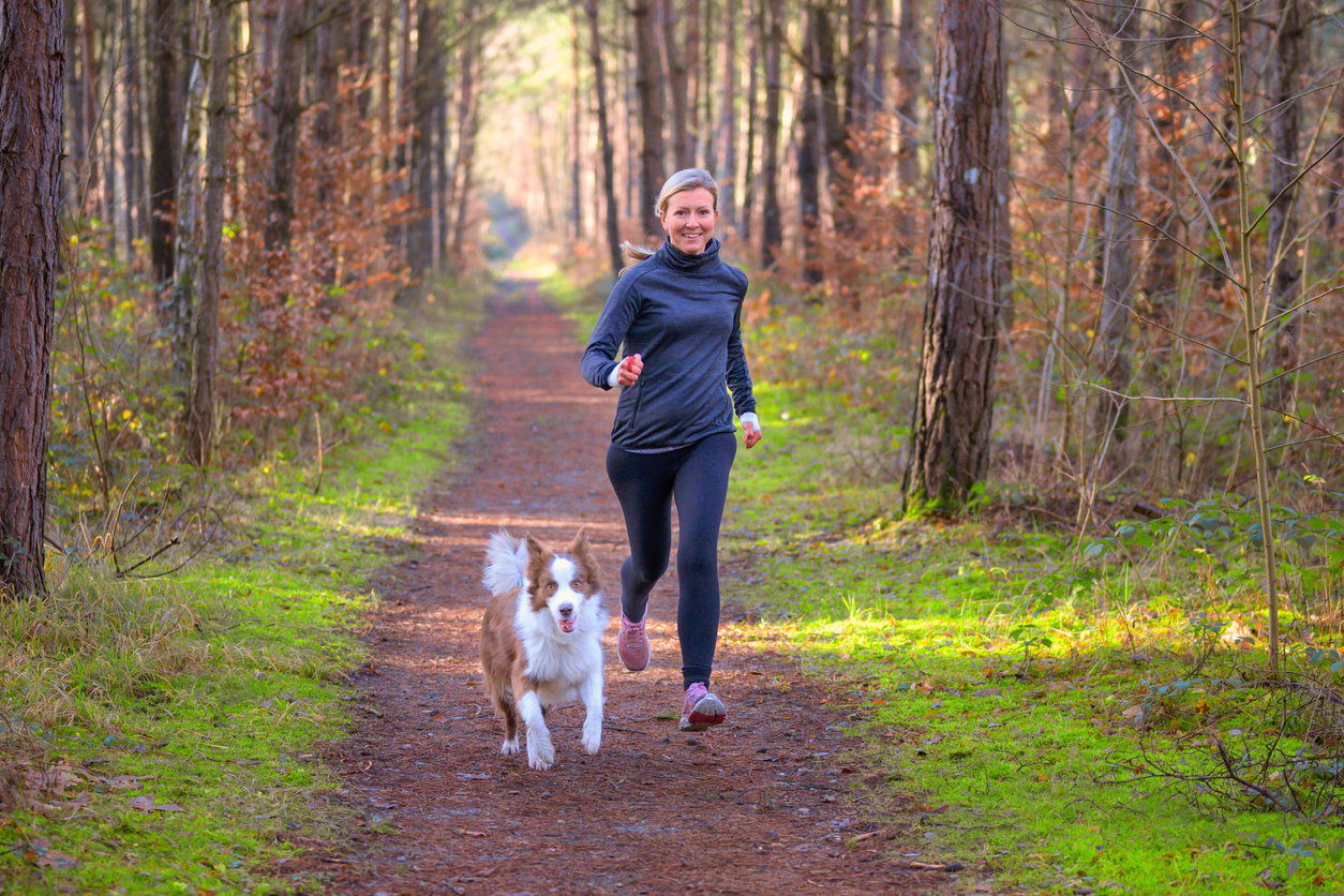 A person running with a dog on a trail, Being Active with Your Pet with Regular Exercise